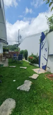 a yard with a surfboard leaning against a building at Herradura Home in Herradura