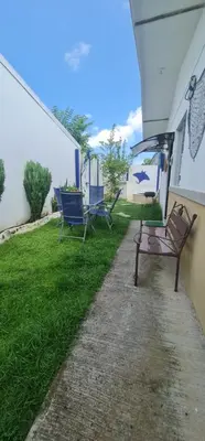 two benches sitting on the side of a house at Herradura Home in Herradura