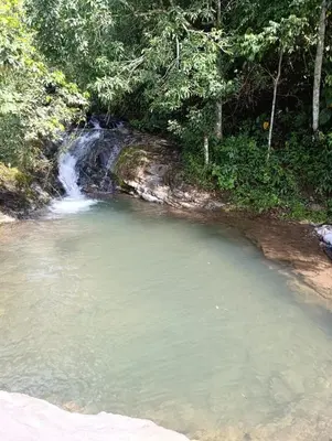 a small pool of water in front of a waterfall at Jessie's Country House Rivas in Rivas