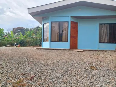 a blue house sitting on top of a gravel yard at Jessie's Country House Rivas in Rivas