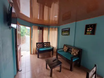 a living room with two chairs and a couch at Jessie's Country House Rivas in Rivas