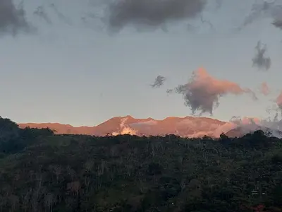 a view of a mountain range with the sun setting at Jessie's Country House Rivas in Rivas