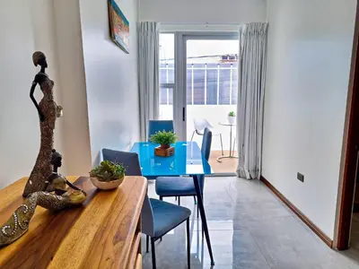a dining room with a blue table and chairs at 714 Studios in San José