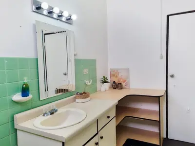 a bathroom with a sink and a mirror at 714 Studios in San José