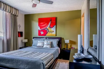 a bedroom with a bed and a painting on the wall at Costa Linda 2-28 in Jacó