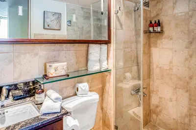 a bathroom with a shower and a toilet and a sink at Costa Linda 2-28 in Jacó