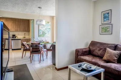 a living room with a couch and a table at Costa Linda 2-28 in Jacó