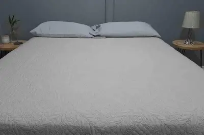 a white bed with two pillows on top of it at Casa San Gerardo in Bagaces