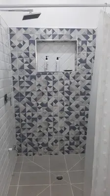a bathroom with a shower with blue and white tiles at Casa San Gerardo in Bagaces