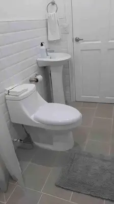 a bathroom with a white toilet and a sink at Casa San Gerardo in Bagaces