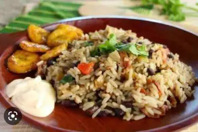 a plate of food with rice and vegetables and potatoes at Casa San Gerardo in Bagaces