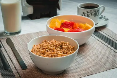two bowls of granola and fruit on a table at Hotel El Cocobolo Food&Rest Room 1 B&B WiFi AC Pkg Free Swimmingpool in Ahogados