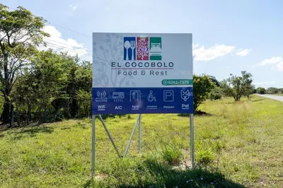 a sign on the side of a road at Hotel El Cocobolo Food&Rest Room 1 B&B WiFi AC Pkg Free Swimmingpool in Ahogados