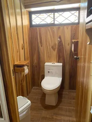 a small bathroom with a toilet and a window at Casa Gratitud in Paquera