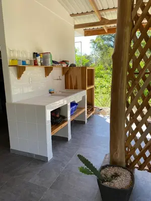 a kitchen with a white counter in a room at Casa Gratitud in Paquera