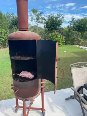 an outdoor grill with a meat inside of it at Casa Gratitud in Paquera