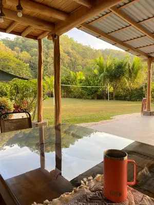 a coffee mug sitting on a table under a porch at Casa Gratitud in Paquera