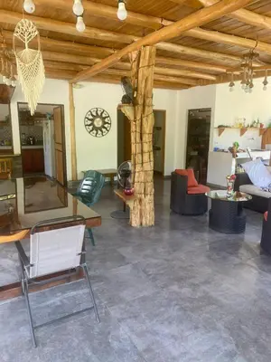 a living room filled with furniture and a wooden ceiling at Casa Gratitud in Paquera