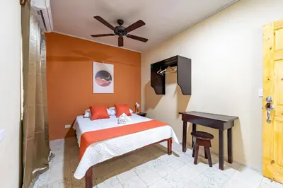 a bedroom with a bed and a desk in it at Hotel El Cocobolo Food&Rest Room 7 B&B WiFi AC Pkg Free Swimmingpool in Ahogados