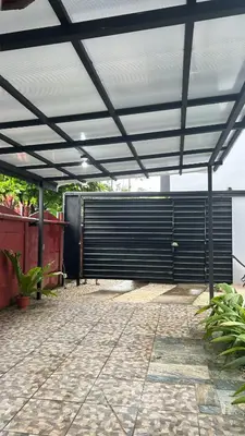 a large black garage door with a roof at Villa JADE, La Fortuna Downtown in Fortuna