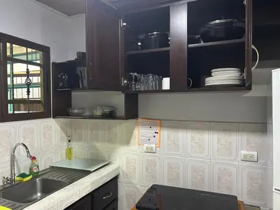a kitchen with a sink and a counter top at Villa JADE, La Fortuna Downtown in Fortuna