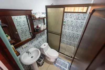 a bathroom with a toilet and a sink and a shower at Villa JADE, La Fortuna Downtown in Fortuna