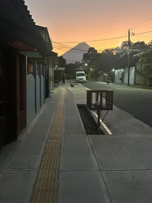 a bench on a sidewalk next to a street at Villa JADE, La Fortuna Downtown in Fortuna