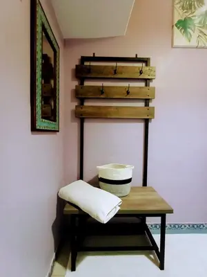 a shelf in a room with a table with a pillow at Nirvana Apartament Hostal in Alajuela City