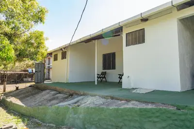 a house with a green lawn in front of it at Hotel El Cocobolo Food&Rest Room 2 B&B WiFi AC Pkg Free Swimmingpool in Ahogados