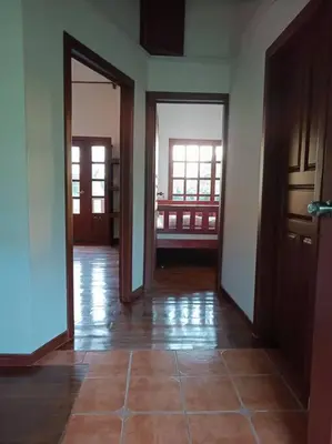 an empty hallway with doors and a tile floor at Manantial de Vida in Bejuco
