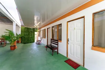 a hallway with a white door and a green floor at Hotel El Cocobolo Food&Rest Room 3 B&B WiFi AC Pkg Free Swimmingpool in Liberia