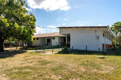 a building with a large white screen in the yard at Hotel El Cocobolo Food&Rest Room 3 B&B WiFi AC Pkg Free Swimmingpool in Liberia