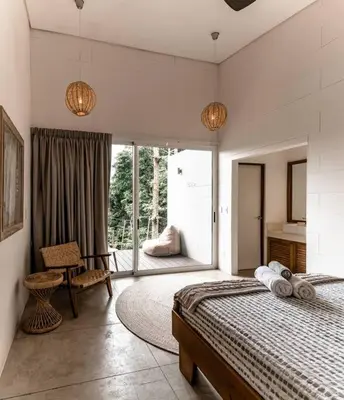 a bedroom with a bed and a large window at BoHo Home in Gated Eco Residence marAmar - Top location in Santa Teresa Beach