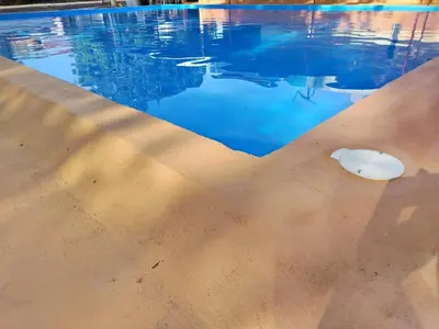 a swimming pool with a rock in the water at Hotel El Cocobolo Food&Rest Room 4 B&B WiFi AC Pkg Free Swimmingpool in Liberia