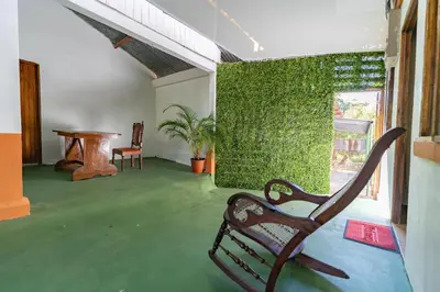 a room with a bench and a green wall at Hotel El Cocobolo Food&Rest Room 4 B&B WiFi AC Pkg Free Swimmingpool in Liberia