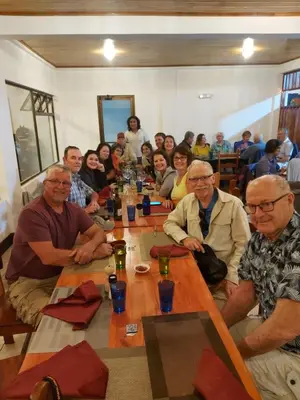 a group of people sitting around a long table at Alisson Hotel y Restaurant in Monteverde Costa Rica