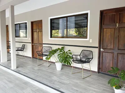 a group of chairs sitting on a porch at Natüra Hotel Monteverde in Monteverde Costa Rica