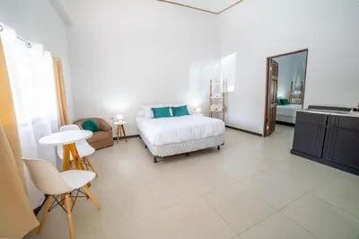 a bedroom with a bed and a table and chairs at Natüra Hotel Monteverde in Monteverde Costa Rica