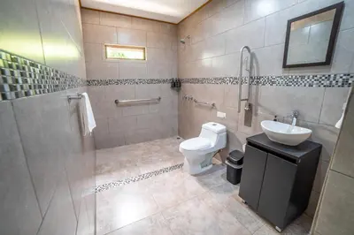 a bathroom with a toilet and a sink at Natüra Hotel Monteverde in Monteverde Costa Rica