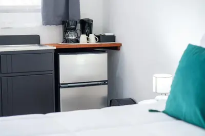 a room with a bed and a counter with a kitchen at Natüra Hotel Monteverde in Monteverde Costa Rica