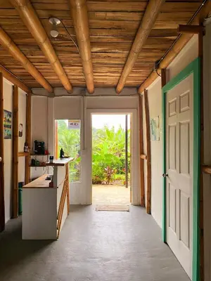 an open door in a room with a hallway with a door at Flor de bambú in Uvita