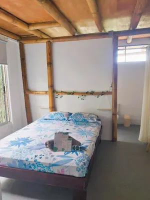 a bedroom with a bed with a box on it at Flor de bambú in Uvita