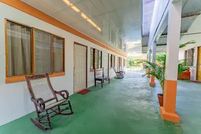 an empty corridor of a building with a chair at Hotel El Cocobolo Food&Rest Room 5 B&B WiFi AC Pkg Free Swimmingpool in Liberia