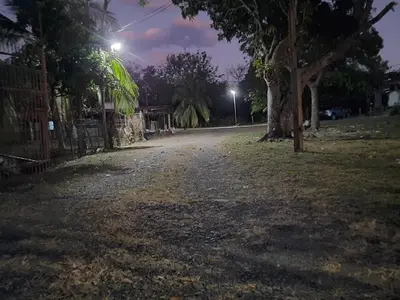 an empty street at night with trees and lights at Hotel El Cocobolo Food&Rest Room 5 B&B WiFi AC Pkg Free Swimmingpool in Liberia