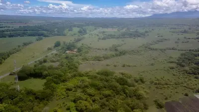 an aerial view of a field with trees and a road at Hotel El Cocobolo Food&Rest Room 6 B&B WiFi AC Pkg Free Swimmingpool in Liberia