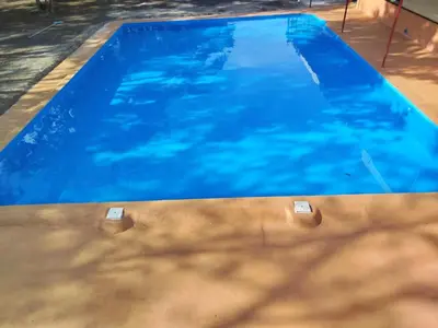 a large blue swimming pool with blue water at Hotel El Cocobolo Food&Rest Room 6 B&B WiFi AC Pkg Free Swimmingpool in Liberia