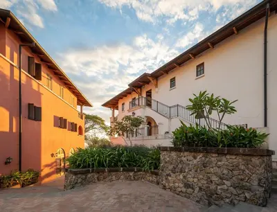 an exterior view of a building with a stone wall at Plaza Mercado 24 At Las Catalinas in Playa Danta