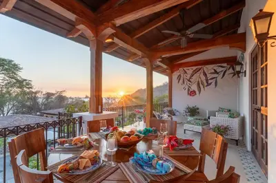 a dining room with a table and chairs on a balcony at Plaza Mercado 24 At Las Catalinas in Playa Danta