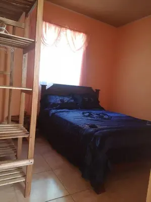 a bedroom with a bunk bed and a window at Casa del Eucalipto in Sabana Redonda