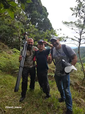 a group of three men standing on a trail with a telescope at Reserva y Estancia Robles Mimosos Lodge in Cartago